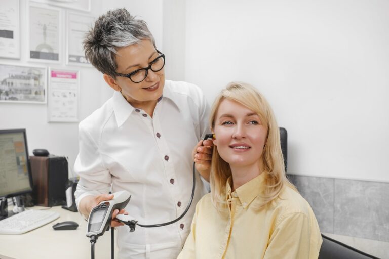 Patient having checkup of hearing at doctor audiologist.